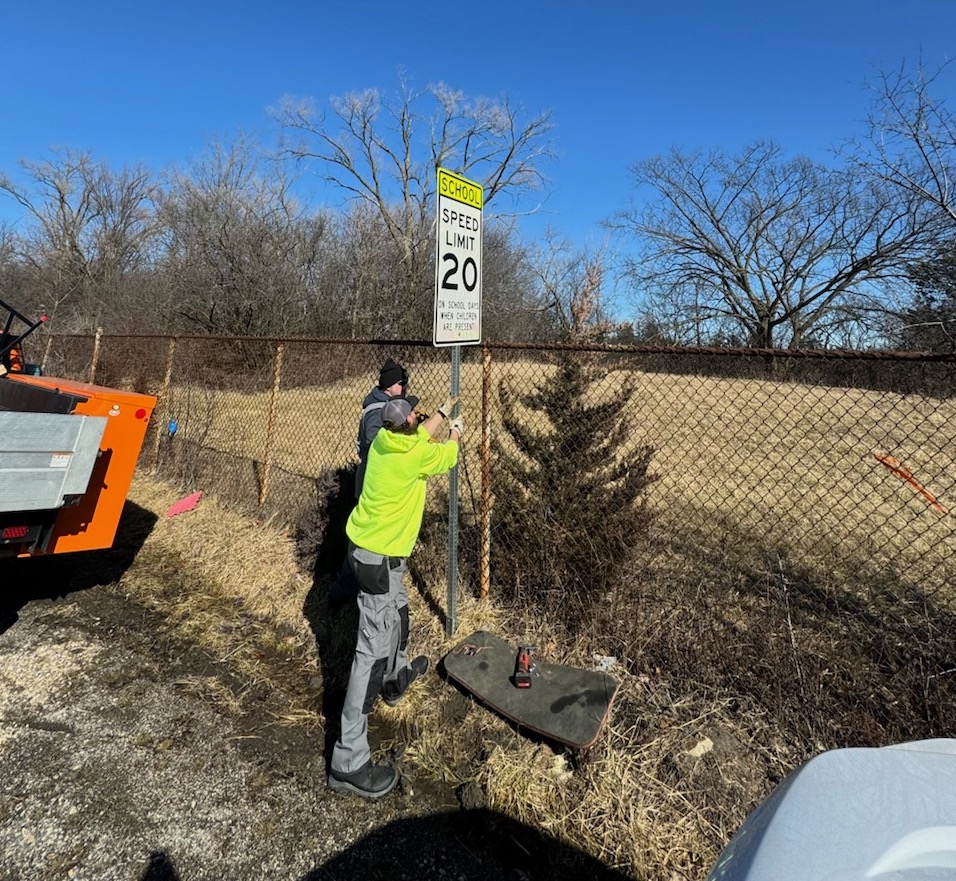 Highway crew installing new sign